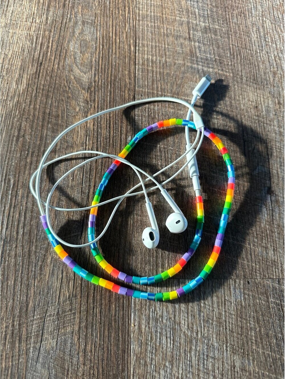 Apple EarPods with Rainbow Beaded Cord Wrap. Comes with lightning adapter.